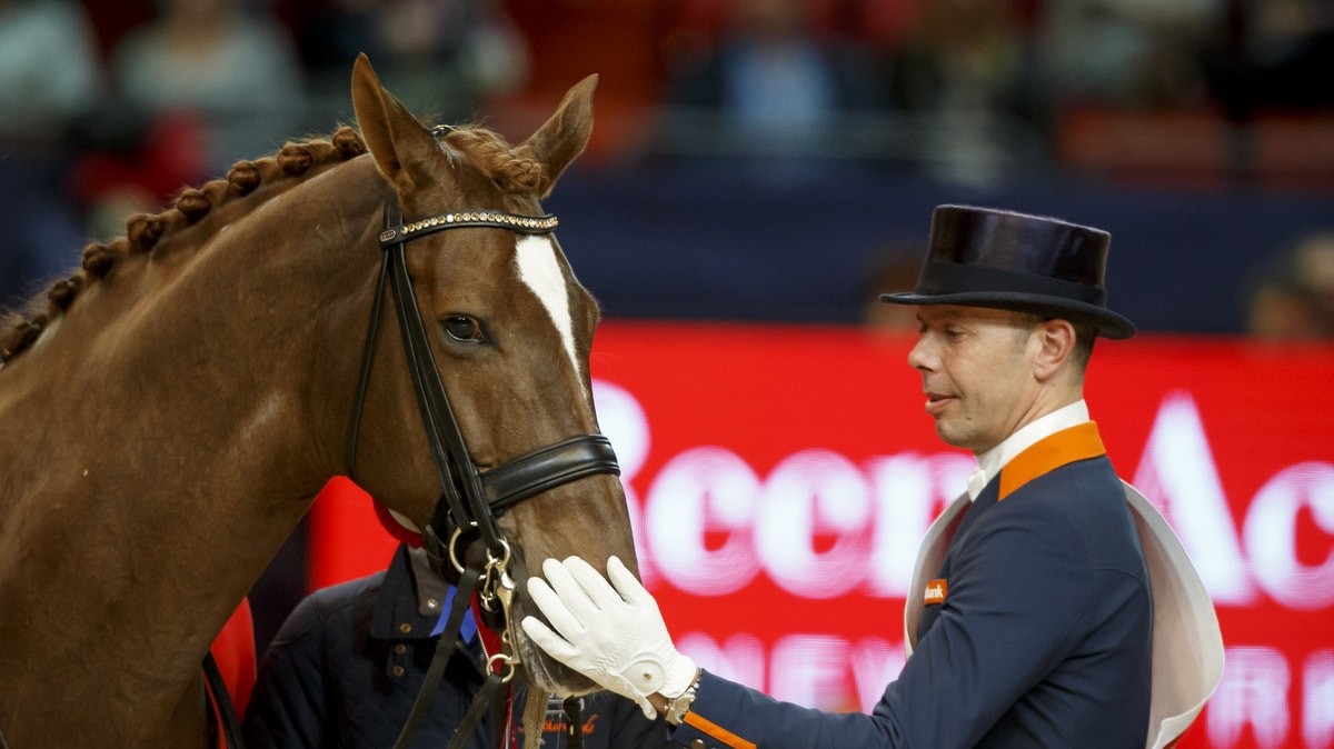 Hans Peter Minderhoud bedankt Glock's Flirt na de zege in de finale van de wereldbeker.